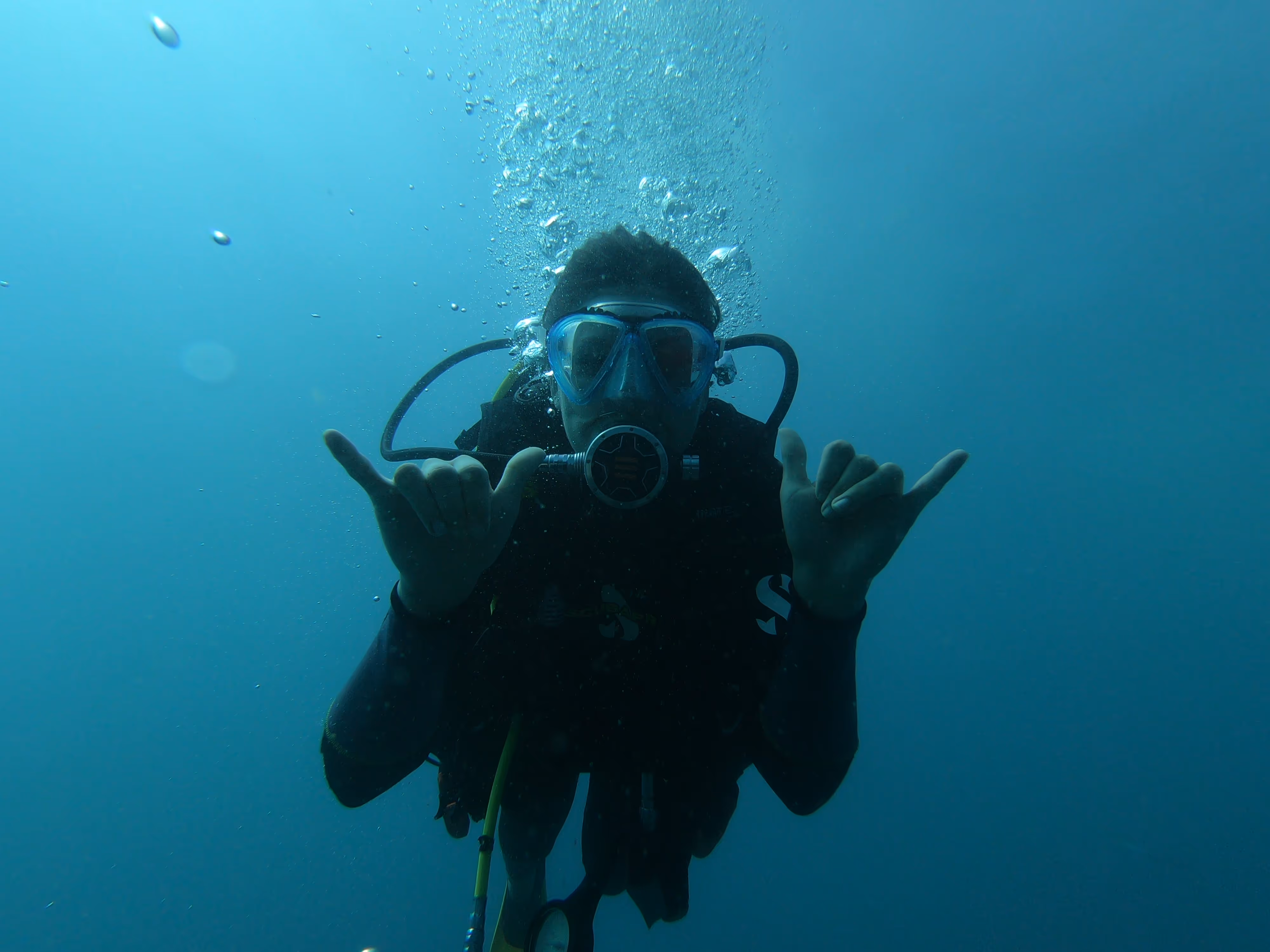 Scuba divers exploring vibrant coral reef at Catalinas Island Costa Rica Scuba divers exploring vibrant coral reef at Catalinas Island Costa Rica
