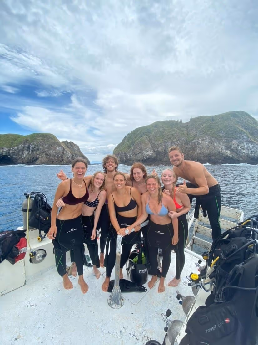 Happy divers on boat after successful diving tour Happy divers on boat after successful diving tour